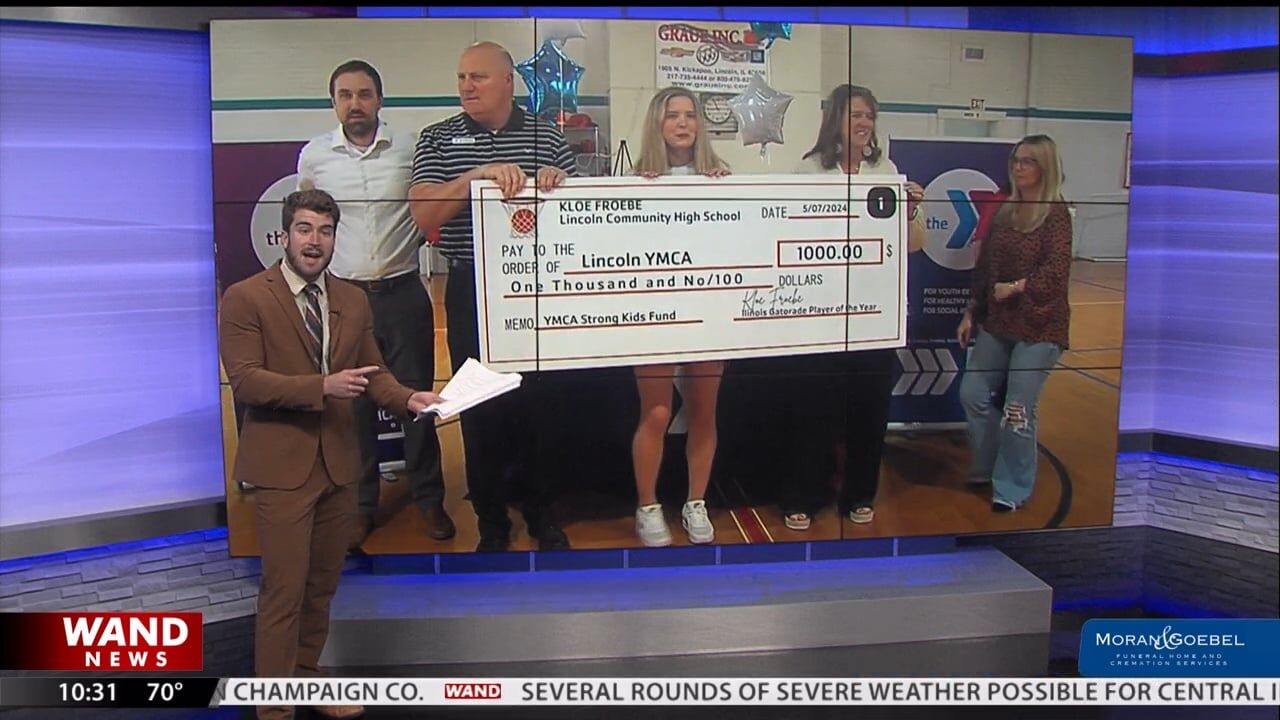 Kloe Froebe delivers $1000 check to Lincoln Area YMCA